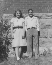 1950s Boy Girl Smiling Portrait Brick Wall Childhood Friends Outdoors