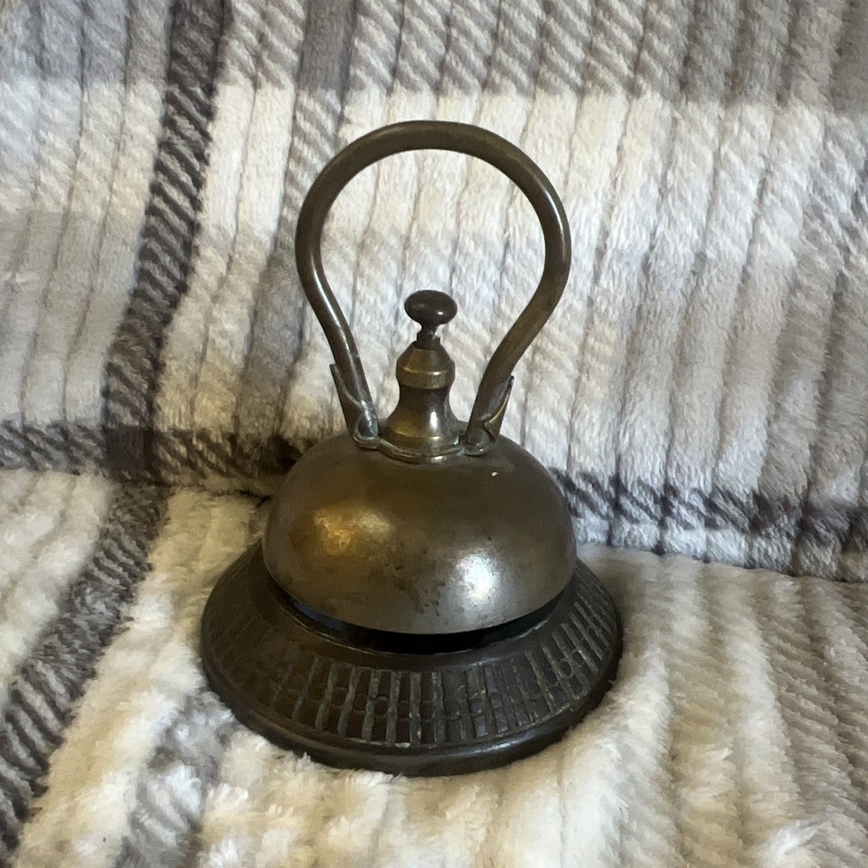 An authentic Victorian brass-and-iron hotel service bell — a weighty, beautifully crafted piece of history that commands any desk or counter.