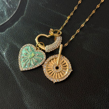Women's mint green necklace with unique sunflower and heart pendant design