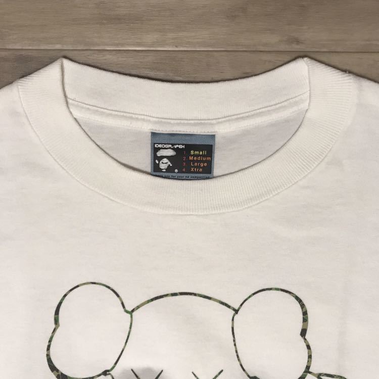 Kaws × BAPE Michelin Man chum T-shirt White A Bathing Ape Kaws × BAPE Michelin Man chum T-shirt White A Bathing Ape