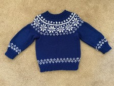 HAND KNIT CHILD S SWEATER FEATURING SNOWFLAKES
