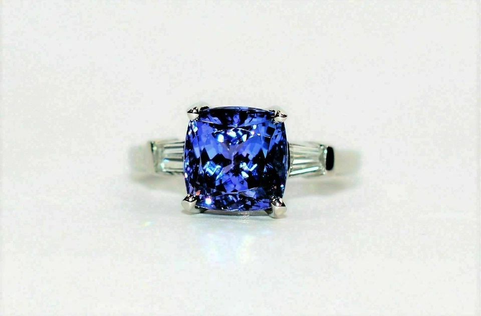 Anillo de tres piedras de diamantes de tanzanita simulada con cojín de 3 quilates enchapado en oro blanco de 14 k. Foto 2 de 4