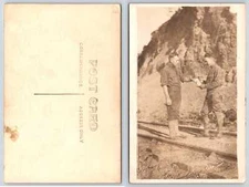 U S SOLDIERS w/ TOBACCO CONTAINER STAND ON TRAIN TRACKS c1910 RPPC Postcard 2Z16