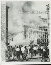 1956 Press Photo Crowd watching firemen spray water on Wanamaker store, New York