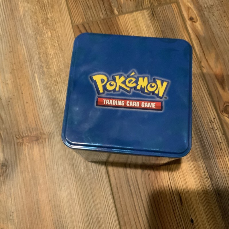 Pokémon Tin With About 500 Cards, 1 Guaranteed Good Card, Plus A Joke Card Used