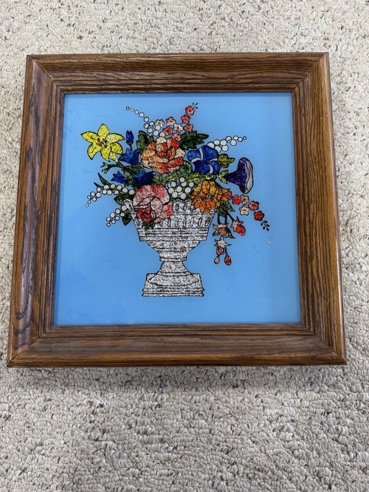 Foil art floral urn under a Lambert blue glass frame — a genuinely distinctive mid-century decorative technique that glows beautifully on a wall.