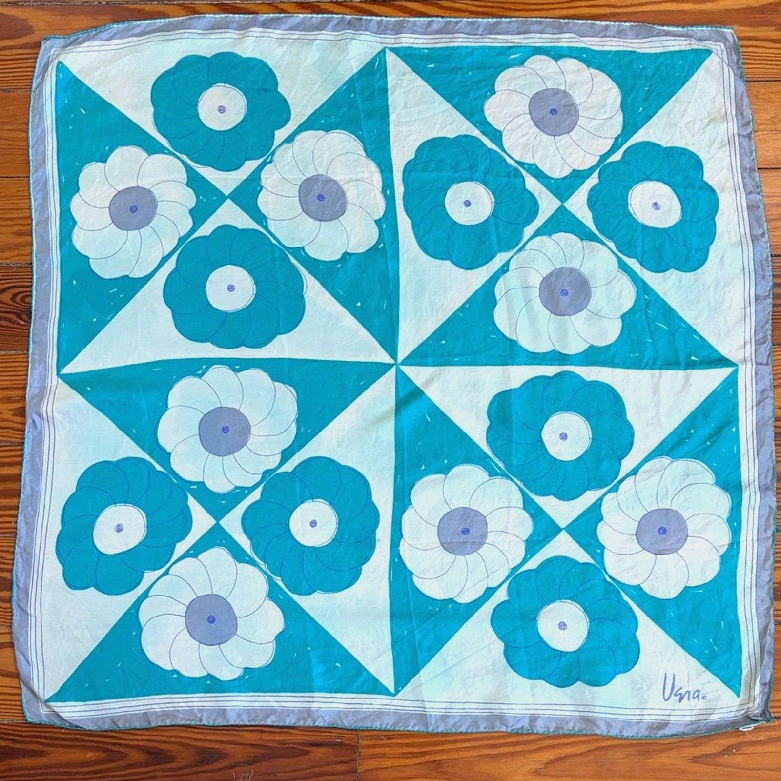 Signed square silk scarf with a blue and white geometric floral pattern