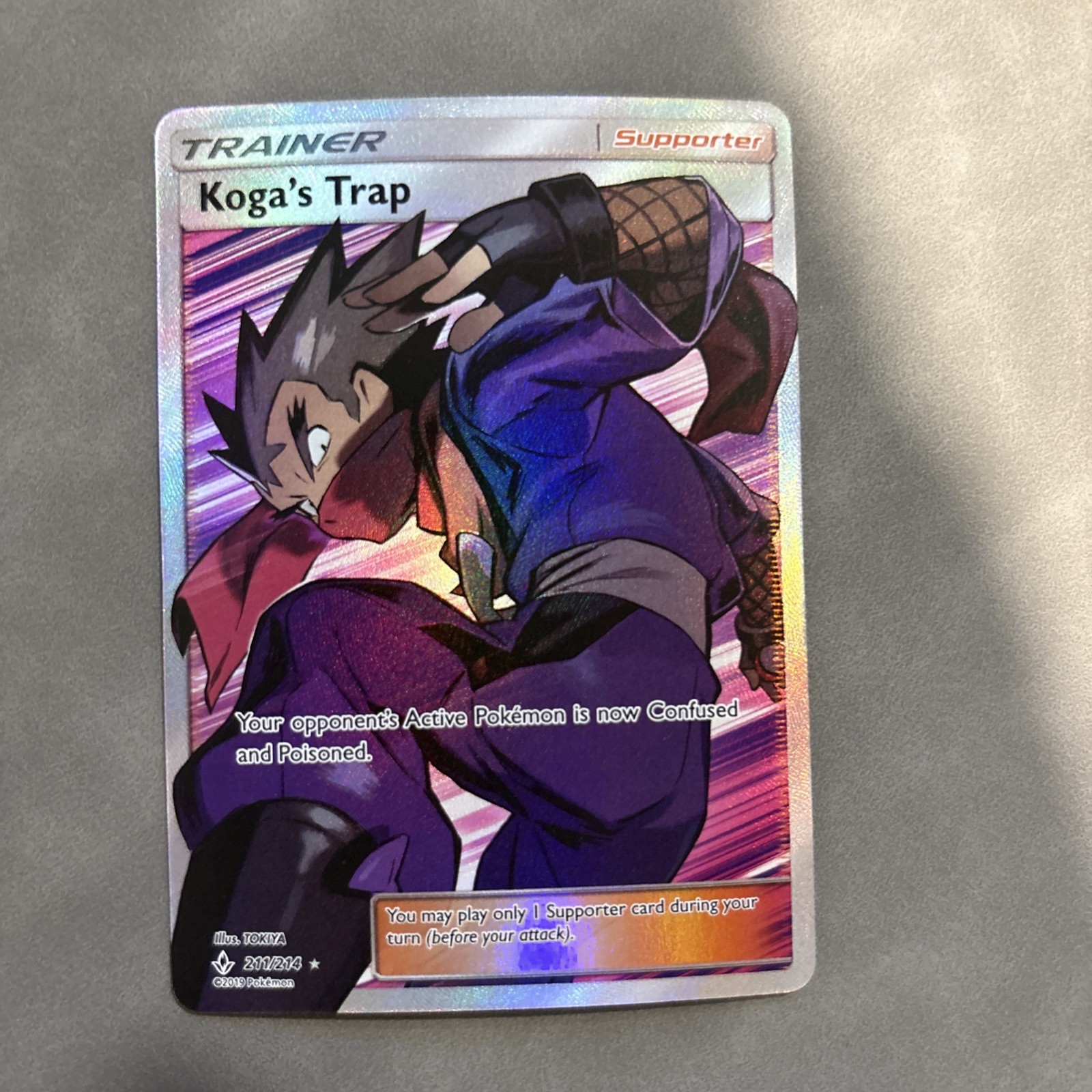 Koga's Trap (Full Art) 211/214 Sm-Unbroken Bonds Holo