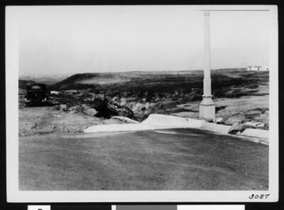 Termination of an unidentified paved street showing an automobile - Old Photo