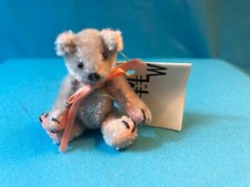 THIS TINY 2" PALE BLUE PLUSH TEDDY BEAR WITH PINK PAWS, MARKED "B BOY" BY MLW