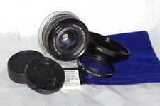 Objectif Nikon F 28mm f2,8 HOYA, bouchons, filtre 1A, pare-soleil et housse TBE.