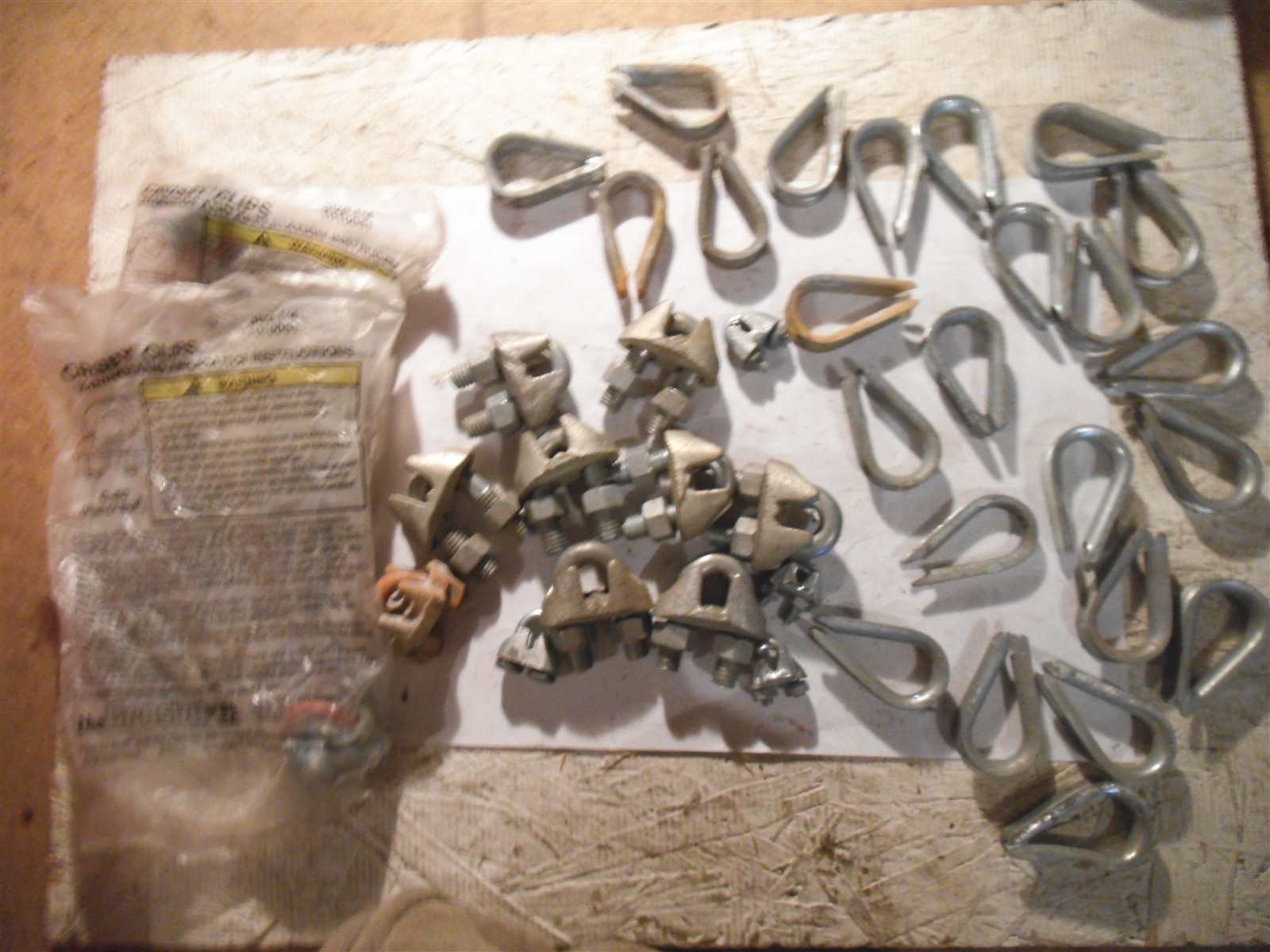 Qty=24: WIRE CABLE THINBLES & Qty=15: CABLE CLAMPS -NEW & USED