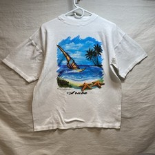 vintage 1980s white t-shirt featuring a graphic of windsurfing in Aruba