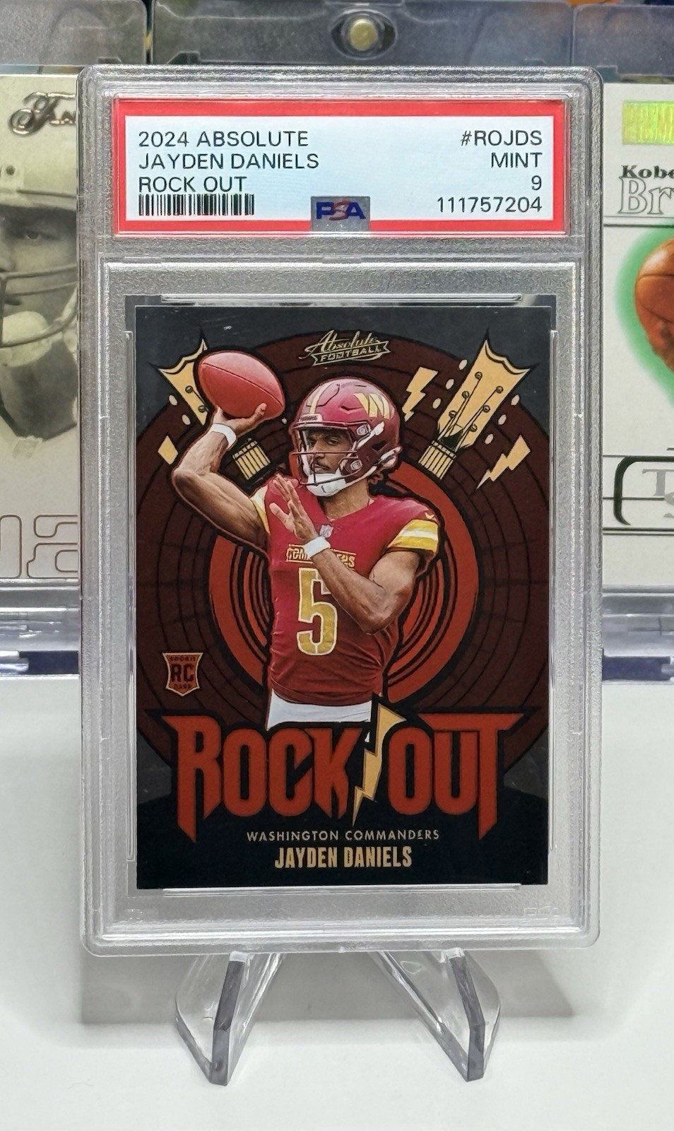 PSA 9 2024 PANINI ABSOLUTE COMMANDERS JAYDEN DANIELS NO.RO-JDS ROCK OUT (RC)
