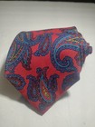 Red ETRO silk tie with yellow and blue paisley pattern, made in Italy, displayed against a plain white background.
