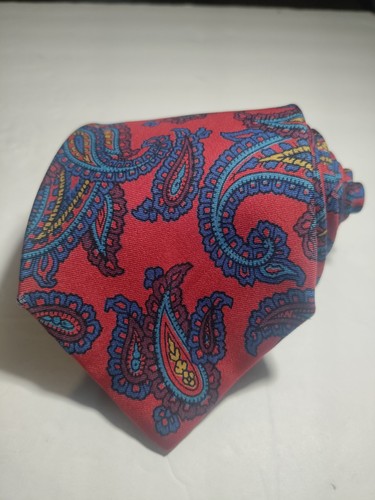 Red ETRO silk tie with yellow and blue paisley pattern, made in Italy, displayed against a plain white background.
