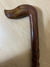 hand-carved wooden walking stick cane featuring a spiral or twisted shaft design