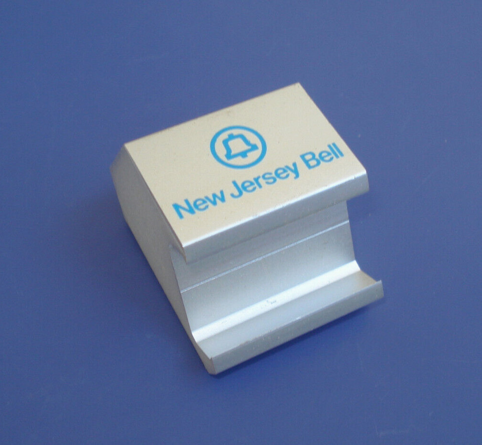 A solid aluminum desk widget made for New Jersey Bell Telephone — a piece of real corporate history with that chunky mid-century industrial look.