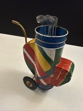 A colorful, abstract metal figurine of a golf bag with clubs.