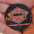 Black round pin with white “80s Night Ranger” text, red “Midnight Madness” lettering, and angular front design.
