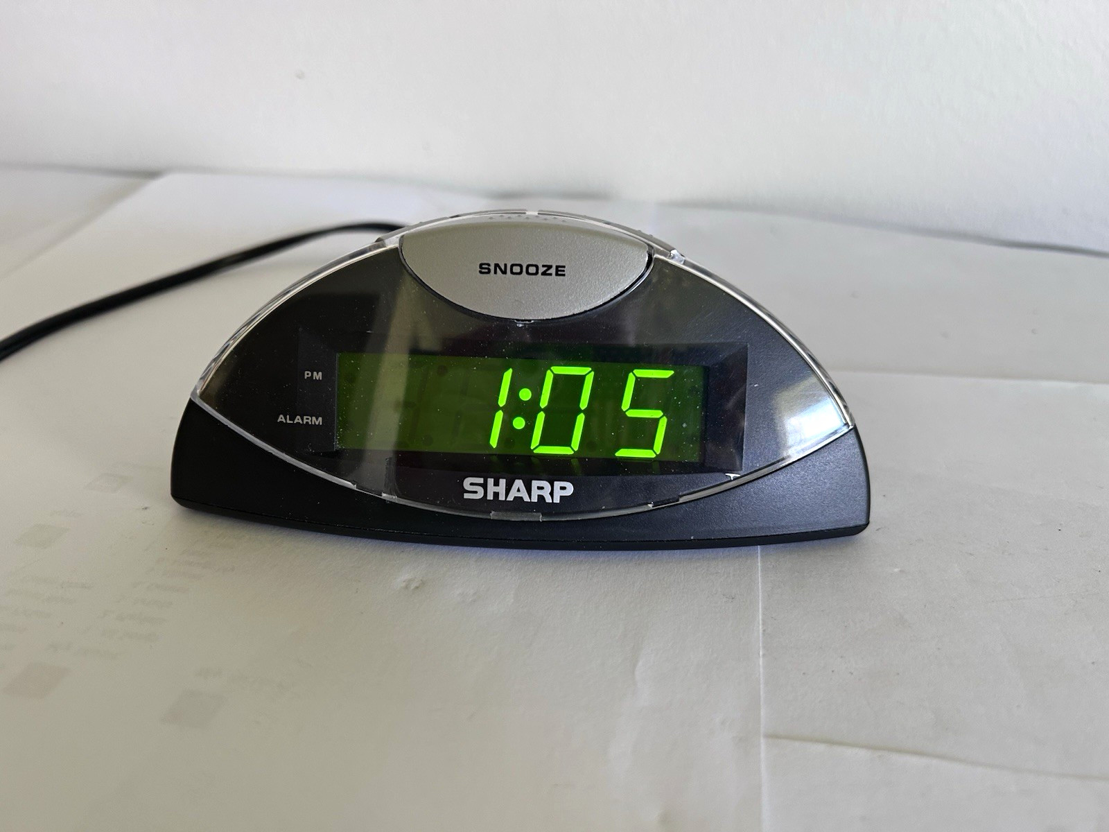 Sharp SPC 019 Digital Alarm Clock Green LED Snooze Plug In Black/Silver Oval photo Sharp SPC 019 Digital Alarm Clock Green LED Snooze Plug In Black/Silver Oval featured image