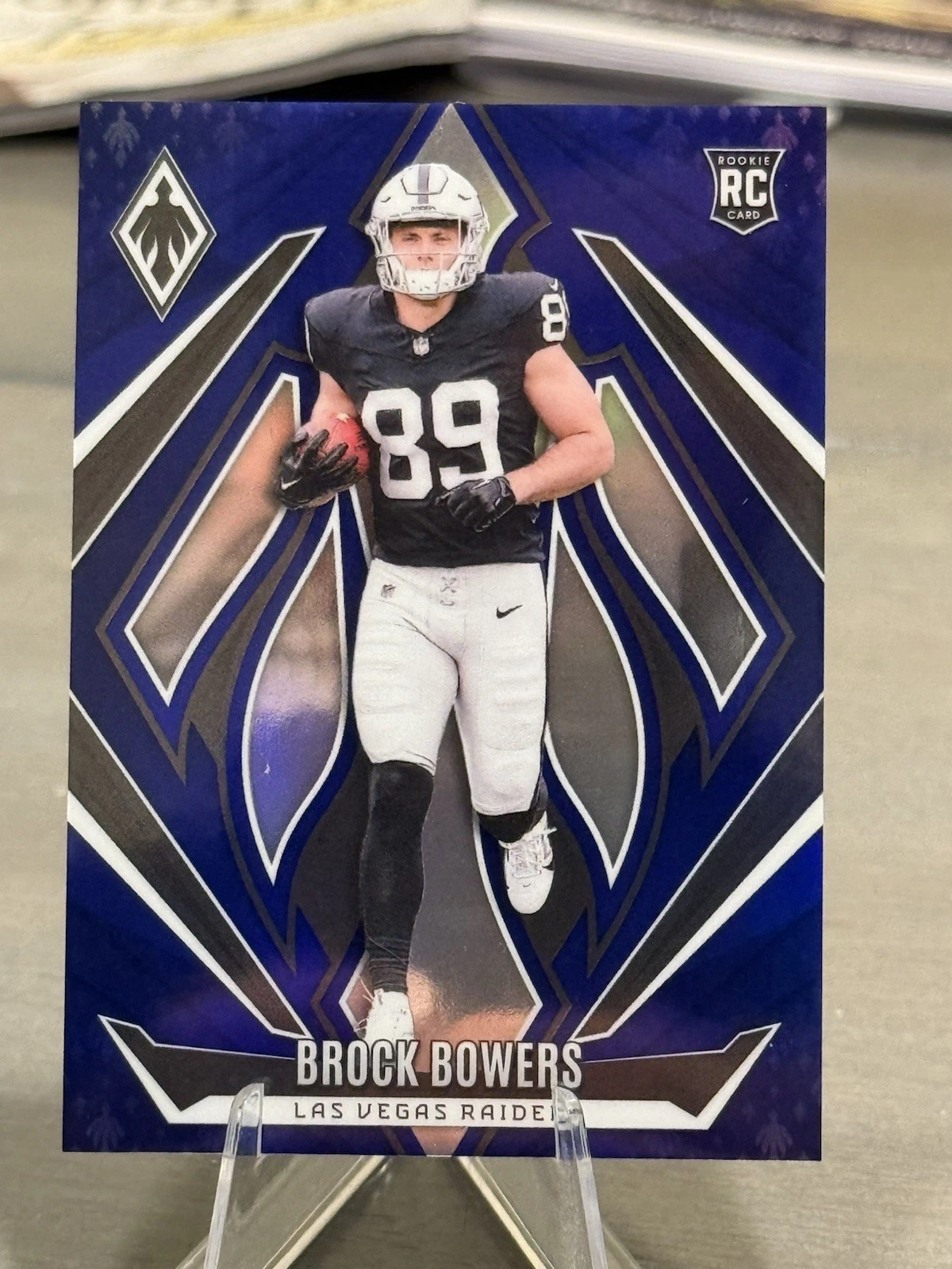 2024 Panini Phoenix Football - Rookies Brock Bowers #165 Blue Prizm /50 (RC)