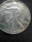 American Eagle Silver Dollar Album. With 4 BU Silver Eagles 1987, 93, 96, 2003
