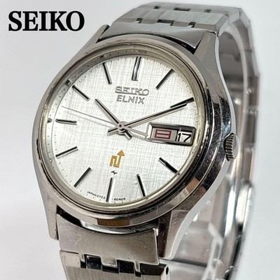 Seiko ELNIX 0703-6011 Quarz Armbanduhr 34 mm silbernes Zifferblatt Armband 16...