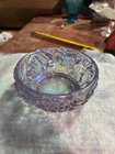 Fenton Art Glass bowl features a vibrant iridescent finish, raised floral design