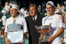 Gaston Gaudio of Argentina is congratulated by former tennis playe- Old Photo