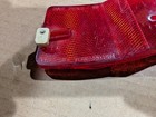 Red vintage 1970s 1980s Micro-Flex bike rim reflector with yellow-orange LEDs and black text reading “THE SIDE TOWARD RIM.”