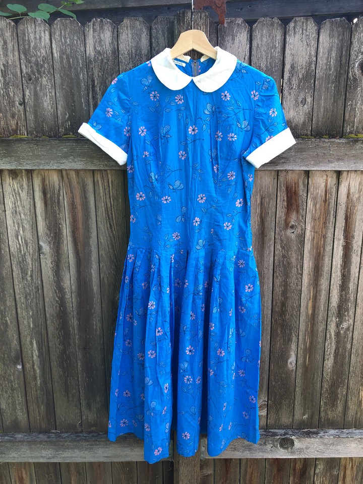 A 1950s rockabilly dress with a novelty doll-collar print — an ultra-rare wearable piece of mid-century fashion history.