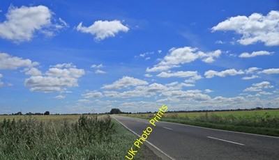 Photo 12x8 B1443 looking east Nene Terrace Big sky, straight road, flat ho c2016