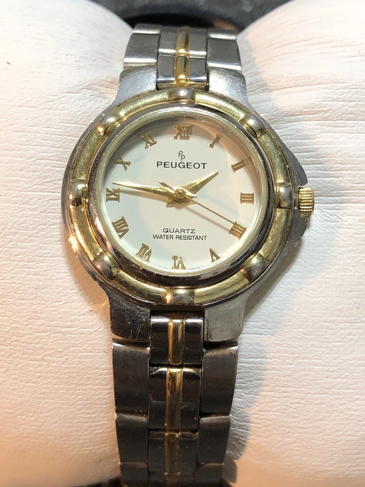 Reloj de vestir vintage Peugeot para mujer tono plata y dorado acero inoxidable número romano Foto 2 de 4