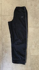 Vintage Nike black nylon track pants, embroidered swoosh and side stripe detail.