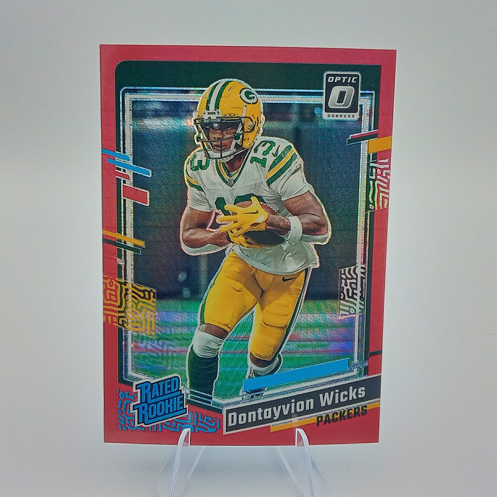 2023 Donruss Optic #249 Dontayvion Wicks Red Hyper Rookie