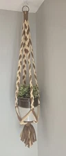 Macrame Plant Hanger  . Tan, brown and cream with metal ring.