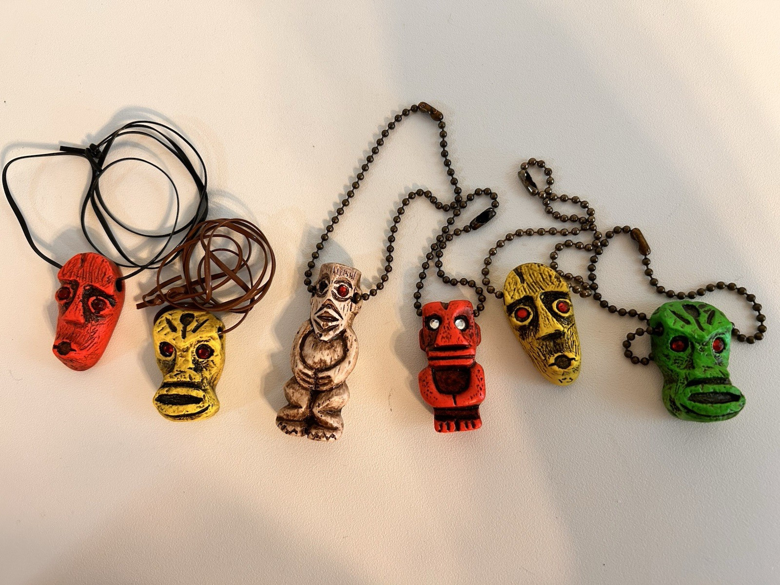 6 PCS. OF FLUORESCENT TIKI'S 3 HAVE KEY CHAINS  3 HAVE CORDS GLOW W/ BLACK LIGHT