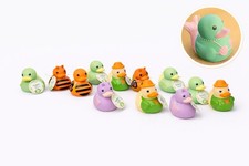 Set of 12 assorted rubber ducks in soft colors, perfect for bath time or decor.