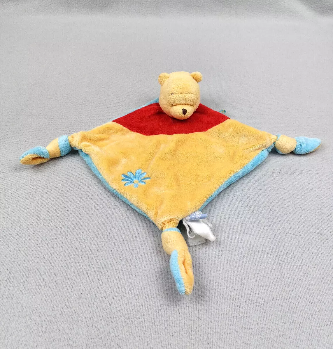 Doudou plat ours Winnie l'ourson bleu jaune rouge fleur Disney