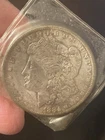 1884-O $1 Morgan Silver Dollar in plastic. 90% Silver. VG.