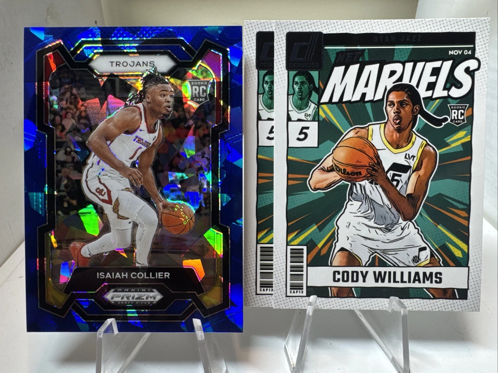 2024 Panini Prizm Draft Isaiah Collier /99 RC Blue Ice. (2) Williams Net Marvel