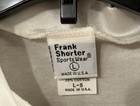 White cotton Frank Shorter Sports Wear cycling jersey, size L, with black tag reading “Made in U.S.A.”