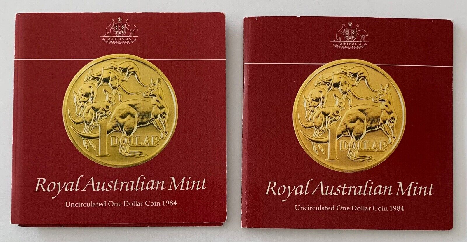 Two 1984 Royal Australian Mint Uncirculated One Dollar Coin with Info Folder