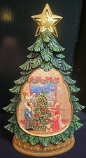 Family Decorating Christmas Tree Scene Holiday Illuminated Swirling Glitter Tree