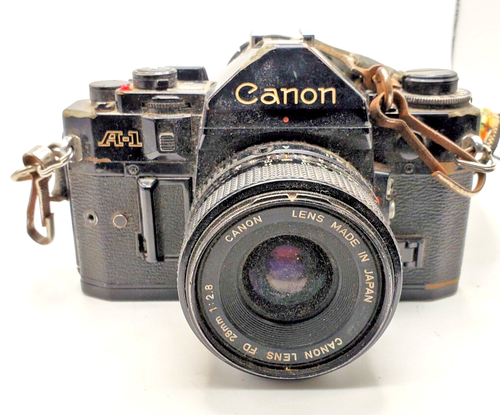 Vtg Canon A-1 35mm Camera w/ 28 m lense shutter works needs deep cleaning