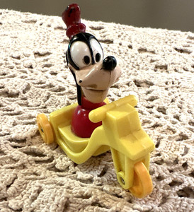 Vintage Goofy Plastic Disney Yellow Tricycle Roll Toy