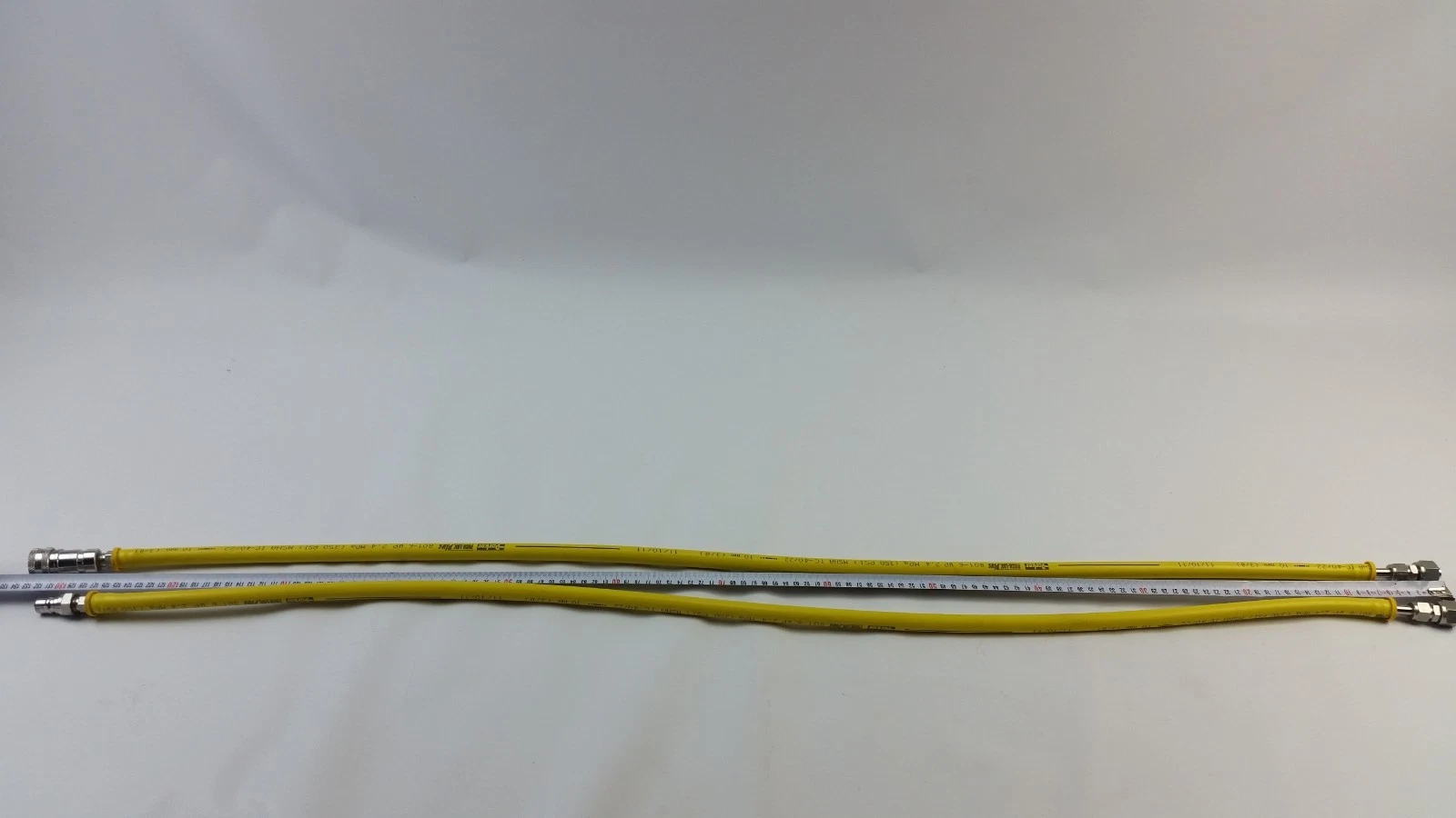 Both Parker 801-6 hoses laid next to a tape measure showing their 1300 mm length