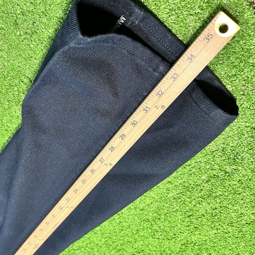 Dark navy blue vintage Wrangler Wrancher 40 x 34 bootcut jeans pants with yellow measuring tape across the waistband.