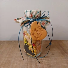 primative amish style small decorative jar filled with corn and other miniatures